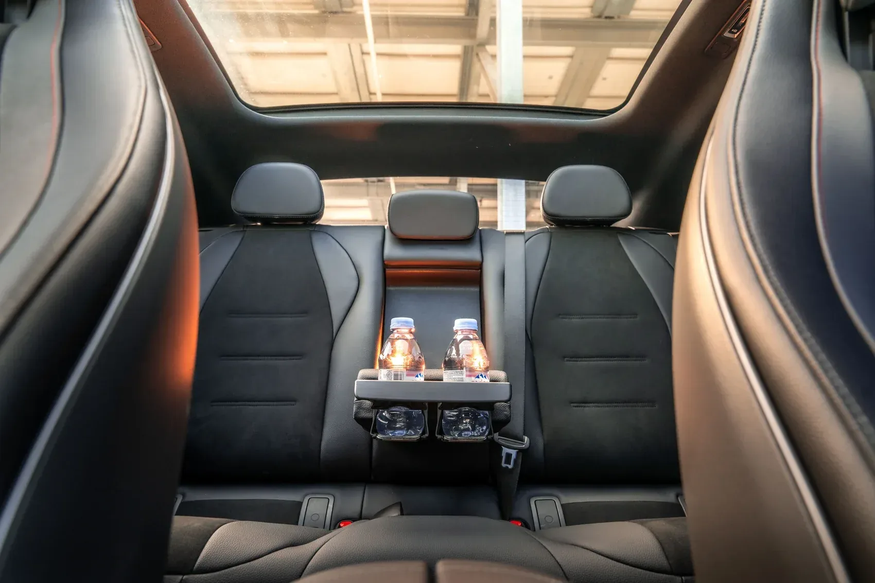 Rear bench seat with centre armrest and bottle holders